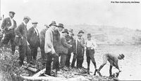 Tom Creighton showing visiting dignitaries the ore outcrop at Flin Flon 1920