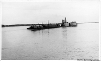 Steam boat pushing a barge 