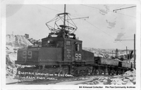 Electric Locomotive and Ore Cars on the Open Pit Track