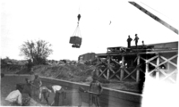 1910s An ore cart being lifted by a crane..