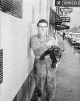 Man with bear cub on Main Street no date