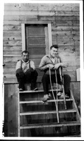 Two men on steps of Ross Lake Rooms 