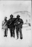Three men in early mining gear, acetalene lamps, Arvo Niemi on the left