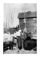 Two men outside Ross Lake Rooms Flin Flon C 1932