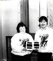 Special Olympics pair with plaques.