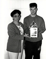 Special Olympics. Athelete receiving a plaque.