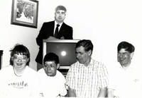 Special Olympics members in front of TV.