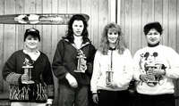 Cranberry Portage team curling with trophies.
