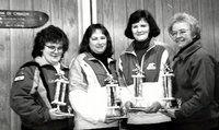 Cranberry Portage team curling with trophies.