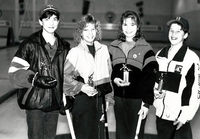Mixed curling team posing with trophies.