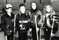 Mixed curling team posing with trophies.