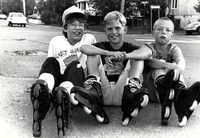 Three young boys on roller blades
