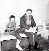 Young lady is being helped putting her skates on.