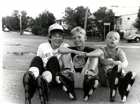 Three young boys on roller blades