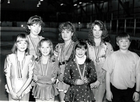 Group of young skaters posing with their medals.