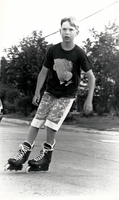 Youn man on roller blades.