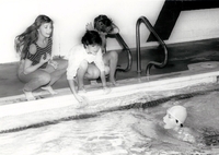 Young swimmer in race in pool