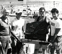 Canoe derby winners with trophy.
