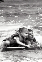 Young swimmers with float board.