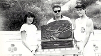 Canoe derby winners with trophy.