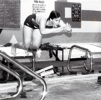 Swimmer in mid jump into the pool