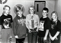 Group photo of swimmers with trophy.