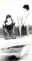 Watching and cheering a swimmer racing.