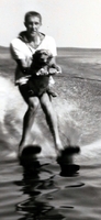 Man waterskiing with dog.