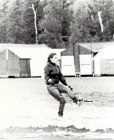 Waterskiing near boathouses.