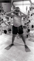 Boy with mask and fins at the pool.