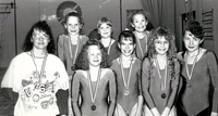 Group photo of young lady swimmers with their medals.