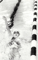 Swimmer racing back stroke.