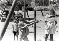 Boy bursting a water balloon with a baseball bat