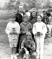 Girls posing with their baseball trophies