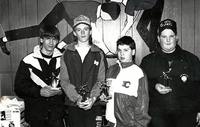 Young curling team with trophies