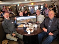 Bob Longmore, Neil Little, Don Longmore and Darrell Nowosad with a Flin Flon photo by Morley Putney