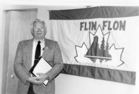 Mayor Gordie Mitchell stands beside the new Flin Flon flag.