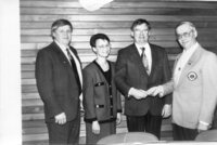 Lions Club Andy Stewart (right) makes presents the Flin Flon School Division with a cheque.