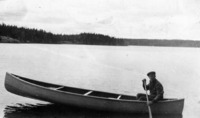   Maurice A. Roche canoeing in an un-named lake.