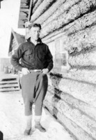 M. A. Roche standing beside main office Flin Flon Camp C 1927