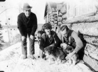 Flin Flon Camp C 1927 - Looks like "Mac" McGilvary kneeling by the puppies