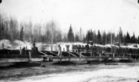 1929/30 Transferring steel rods from flat car to sleighs for Island Falls Haul