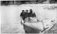 canoe with three at shore