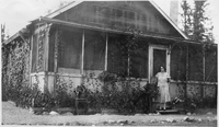 Chlo on stoop of old house