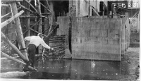 man throwing stone near tailrace footings