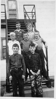 seven boys on school steps