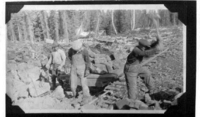 Hand Mucking broken rock at blast face
