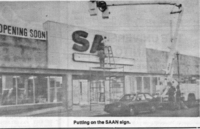 Putting the SAN store sign on the former Hudson Bay Store