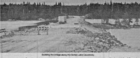 Building the bridge along the Schist Lake Causeway