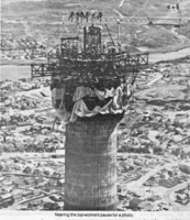 Building the stack, nearing the top workers pause for a photo.